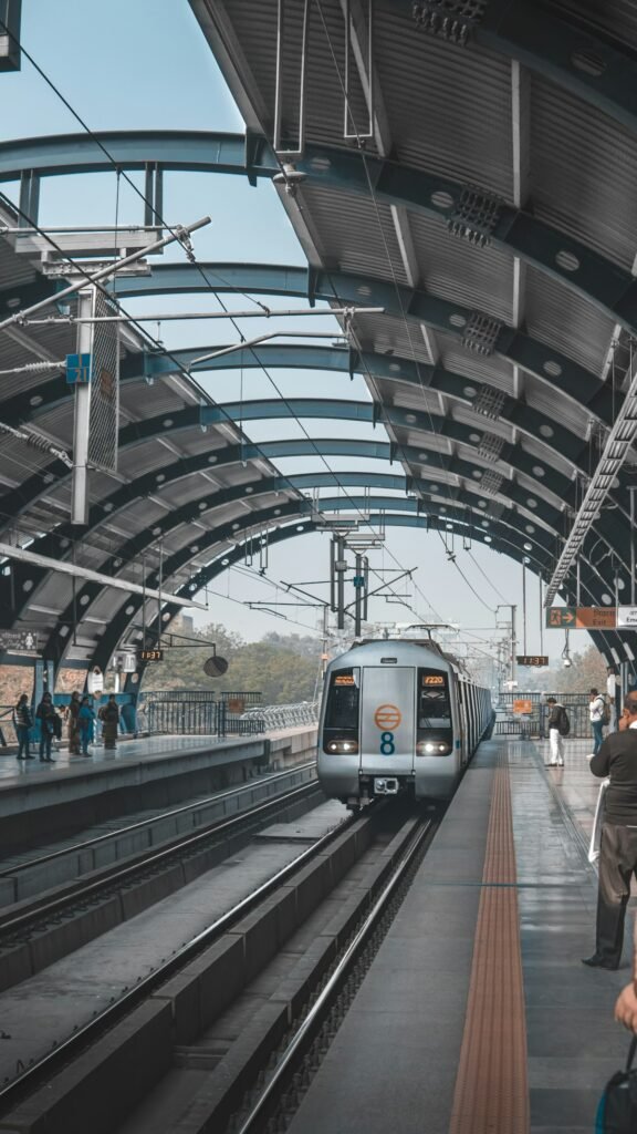 Passengers walking through a busy railway station concourse