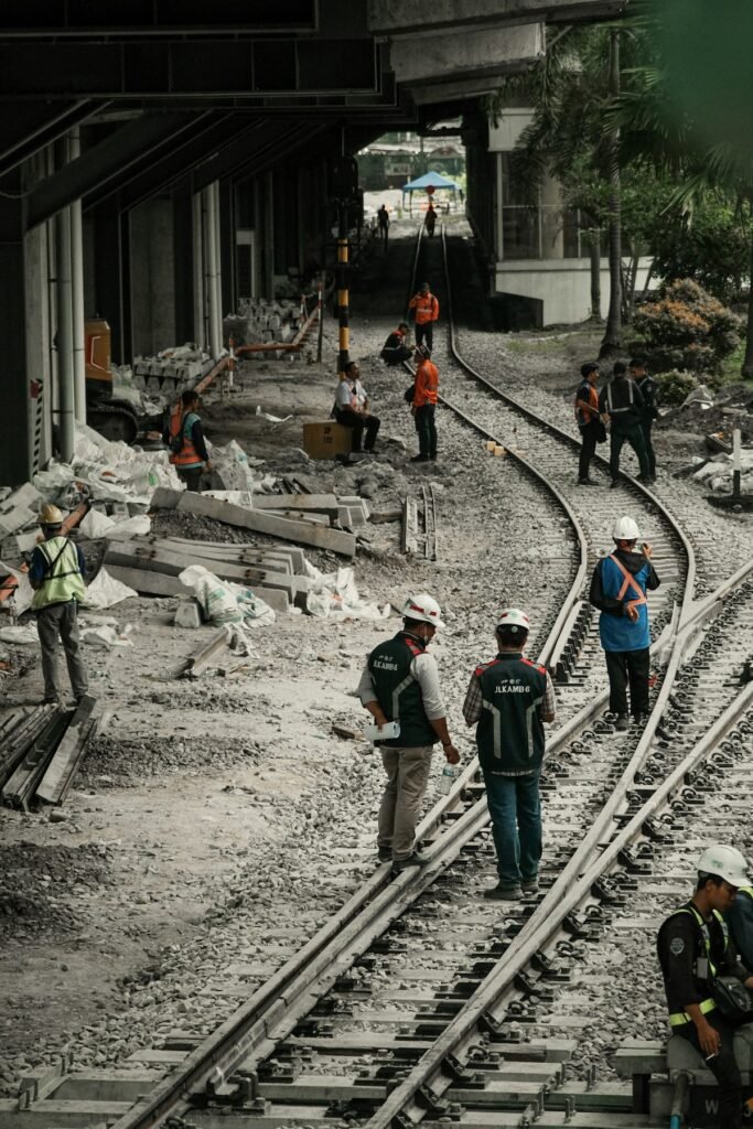 Group of rail workers standing on railway tracks