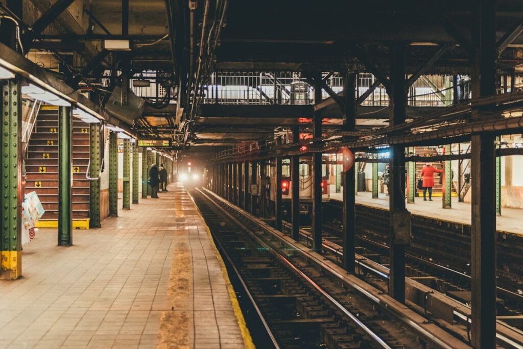 Metro train approaching an underground subway station platform